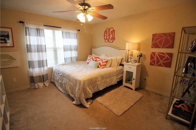 carpeted bedroom featuring ceiling fan and baseboards