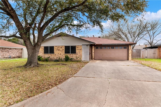 ranch-style home featuring a front lawn, brick siding, concrete driveway, and an attached garage