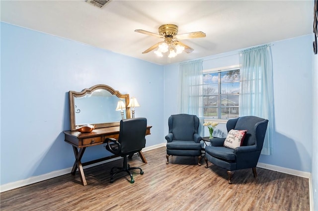 office area with visible vents, wood finished floors, baseboards, and ceiling fan