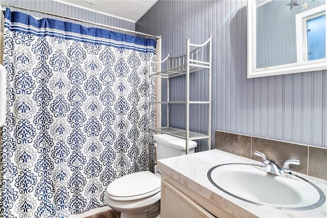 bathroom featuring vanity, a shower with shower curtain, and toilet