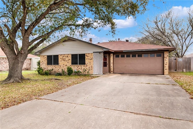 ranch-style home featuring fence, concrete driveway, a front yard, a garage, and brick siding