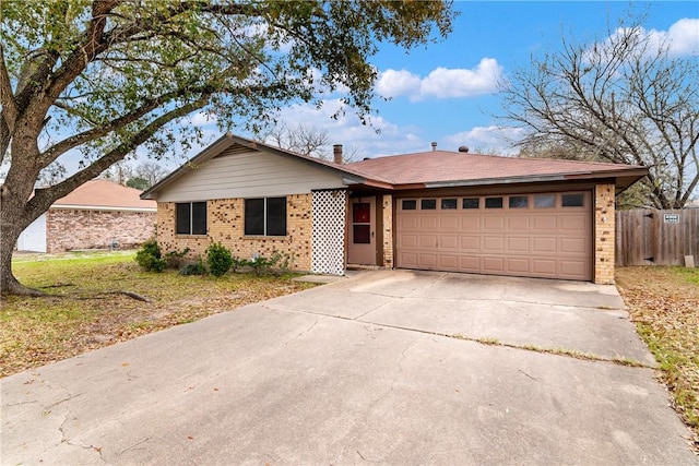 2512 Allen Forest Dr, Bryan, TX 77803 - ranch-style house featuring a garage, brick siding, and driveway