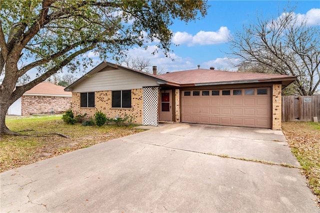 ranch-style house featuring a garage, brick siding, and driveway