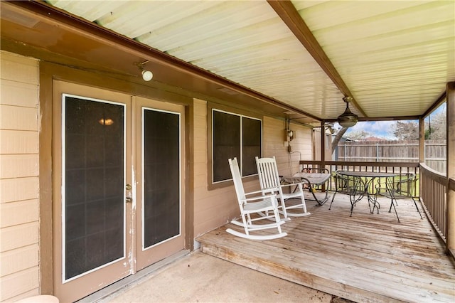 deck with outdoor dining space and fence