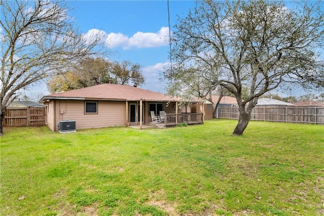 rear view of property featuring a patio area, a yard, and a fenced backyard