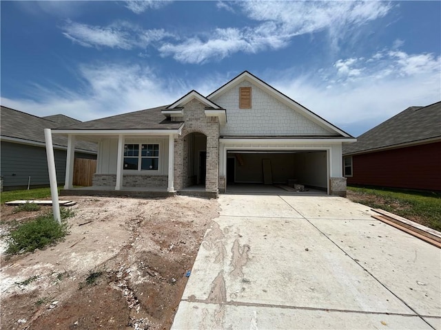 2814 Messenger Way, Bryan, TX 77802 - view of front of home with brick siding, driveway, an attached garage, and covered porch