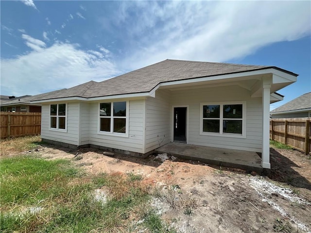 2814 Messenger Way, Bryan, TX 77802 - rear view of house with a fenced backyard, a patio area, and roof with shingles