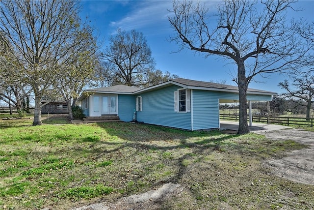 exterior space featuring a carport and a front lawn