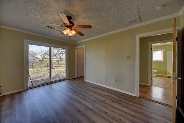 empty room featuring ornamental molding, ceiling fan, hardwood / wood-style floors, and a textured ceiling