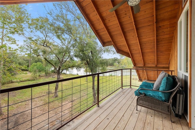 balcony featuring ceiling fan and a water view