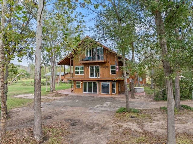 rear view of property with a balcony