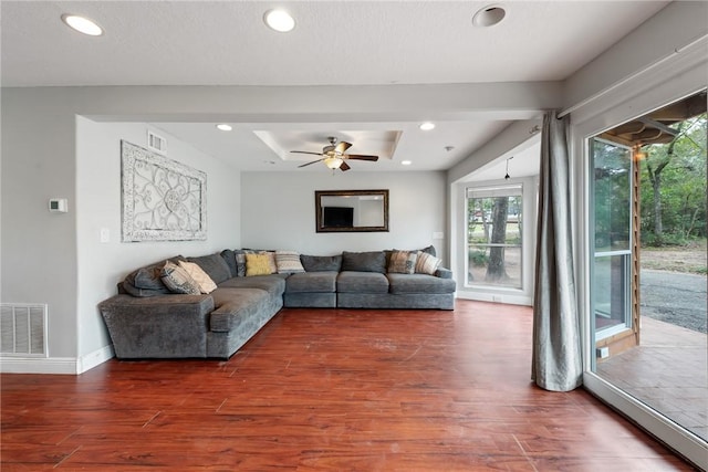 living room featuring dark hardwood / wood-style floors and ceiling fan