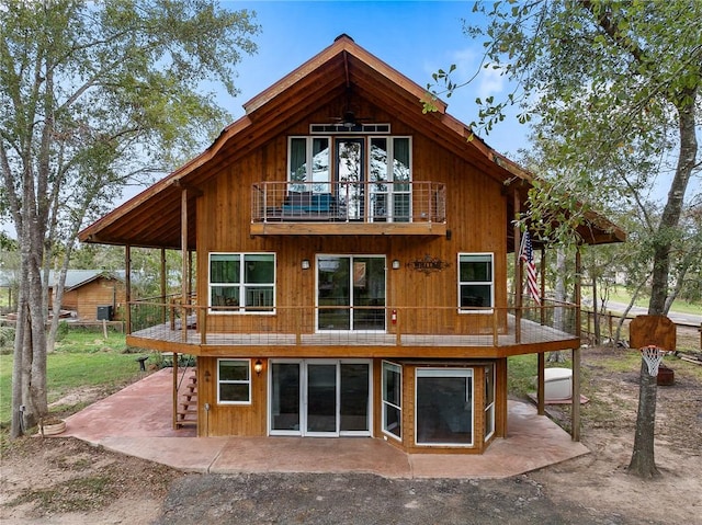 rear view of house with a balcony and a patio