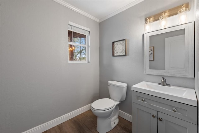 bathroom featuring vanity, toilet, wood-type flooring, and crown molding