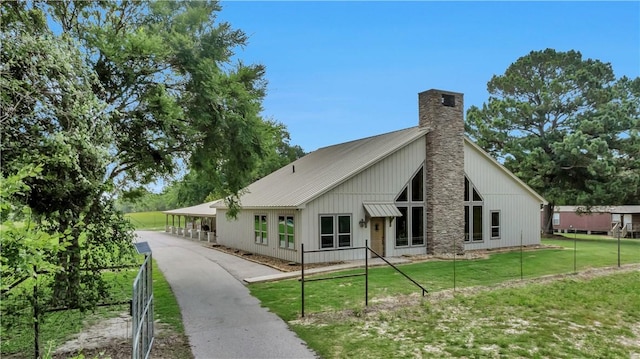 15184 Fm 2620, Bedias, TX 77831 - rear view of house with a chimney and a metal roof