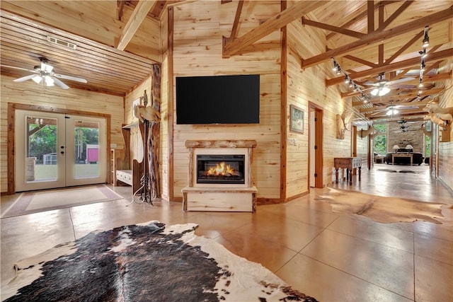 15184 Fm 2620, Bedias, TX 77831 - tiled living area featuring a glass covered fireplace, a ceiling fan, wooden walls, high vaulted ceiling, and healthy amount of natural light