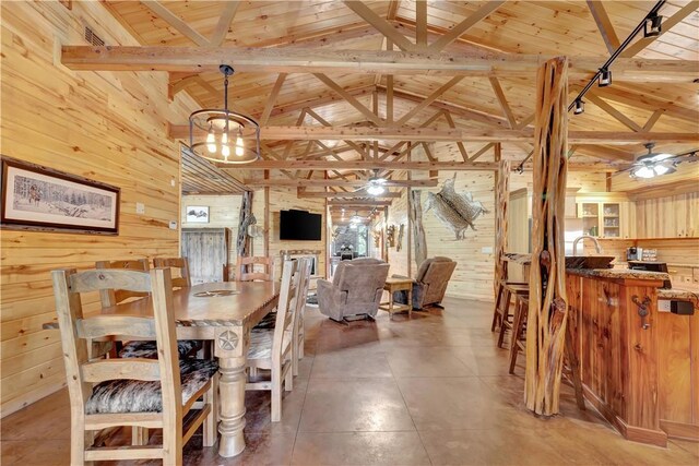 15184 Fm 2620, Bedias, TX 77831 - dining area featuring wooden walls, a chandelier, high vaulted ceiling, a wooden ceiling with exposed beams, and a ceiling fan