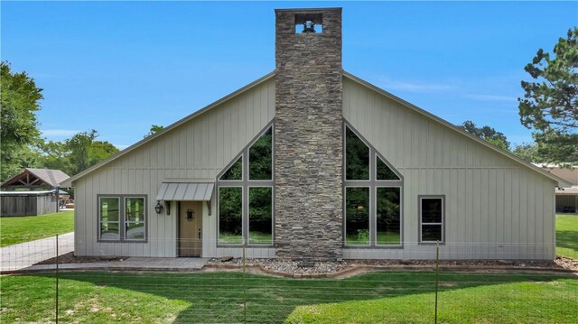 15184 Fm 2620, Bedias, TX 77831 - rear view of property featuring a yard and a chimney