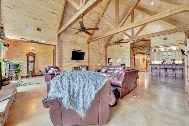 15184 Fm 2620, Bedias, TX 77831 - living area featuring high vaulted ceiling, finished concrete flooring, a wood ceiling with exposed beams, ceiling fan, and wood walls