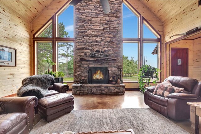 15184 Fm 2620, Bedias, TX 77831 - living room featuring high vaulted ceiling, concrete flooring, wooden walls, a stone fireplace, and wooden ceiling