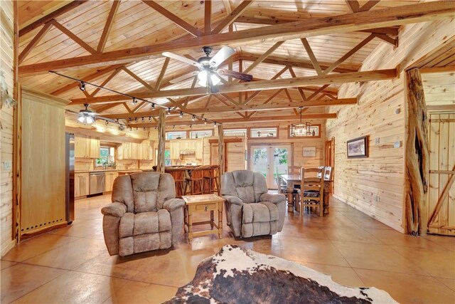 15184 Fm 2620, Bedias, TX 77831 - living room with wood walls, ceiling fan, high vaulted ceiling, french doors, and a wood ceiling with exposed beams