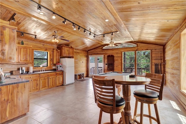 15184 Fm 2620, Bedias, TX 77831 - dining area featuring track lighting, a ceiling fan, wooden walls, vaulted ceiling, and wood ceiling