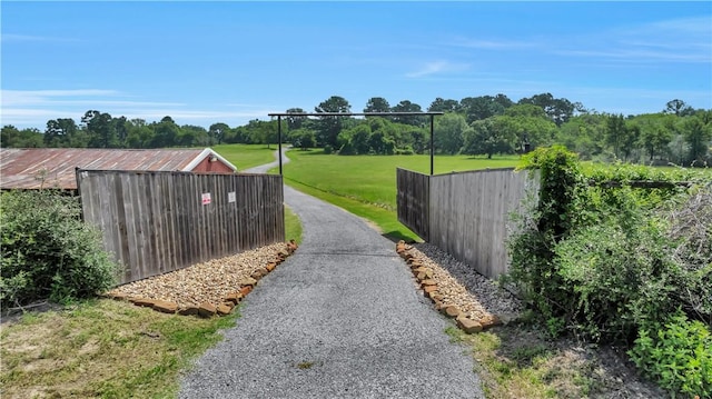 15184 Fm 2620, Bedias, TX 77831 - view of asphalt driveway featuring a gated entry