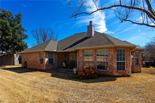 back of property featuring central AC, a yard, and a shed