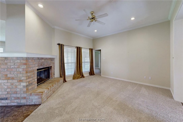 unfurnished living room with crown molding, ceiling fan, light colored carpet, and a brick fireplace