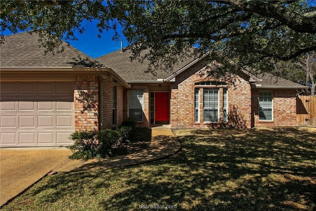 ranch-style home with a front yard and a garage