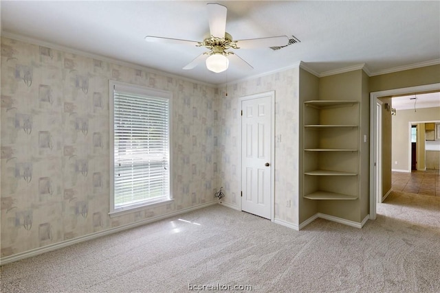 unfurnished bedroom with ceiling fan, light colored carpet, and ornamental molding