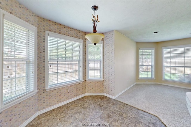 unfurnished dining area with light carpet