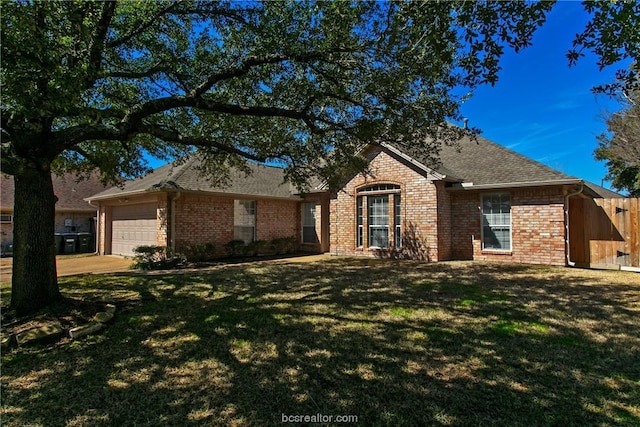 single story home with a garage and a front lawn