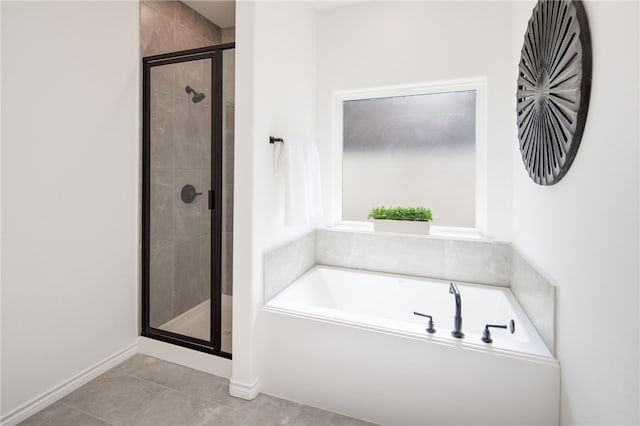 full bath with a stall shower, tile patterned flooring, and a garden tub