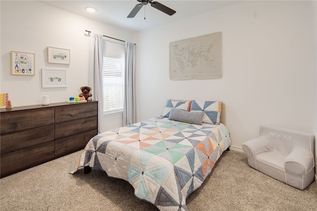 bedroom featuring light carpet, ceiling fan, and baseboards