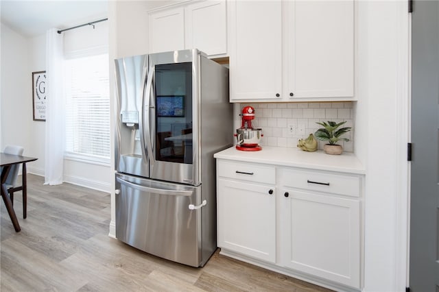 kitchen featuring tasteful backsplash, light wood-style flooring, light countertops, smart refrigerator, and white cabinetry