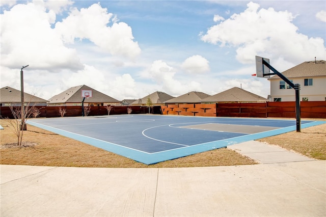 view of basketball court with a residential view, community basketball court, and fence