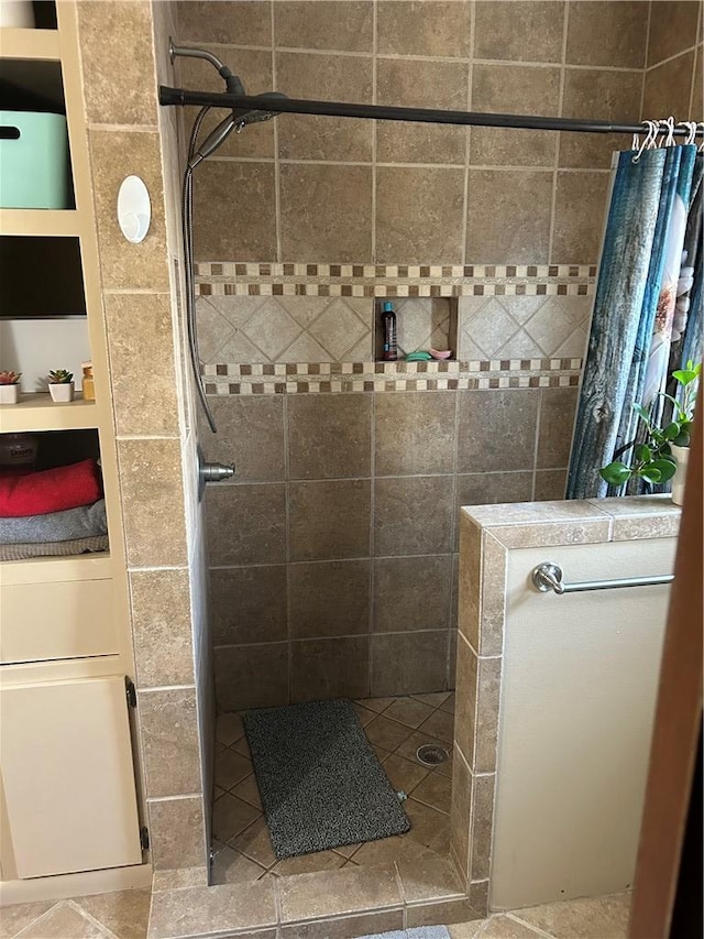 full bath with a tile shower