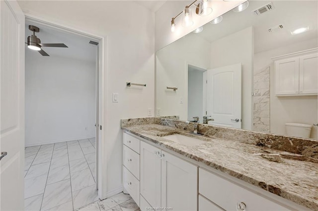 bathroom with ceiling fan, vanity, and toilet