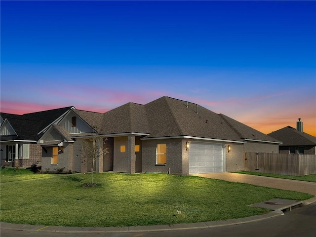 view of front of home featuring a garage and a yard