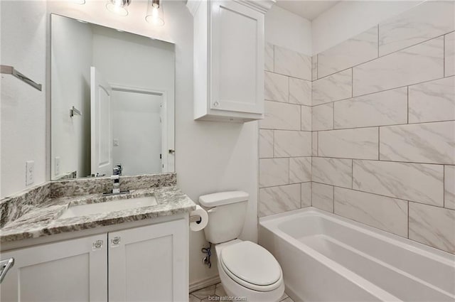 full bathroom featuring vanity, tiled shower / bath combo, and toilet