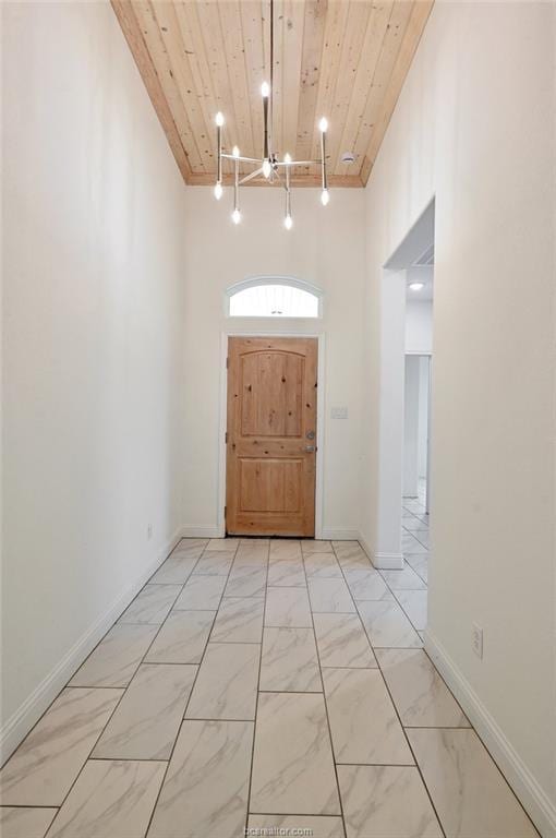 foyer featuring wooden ceiling and an inviting chandelier