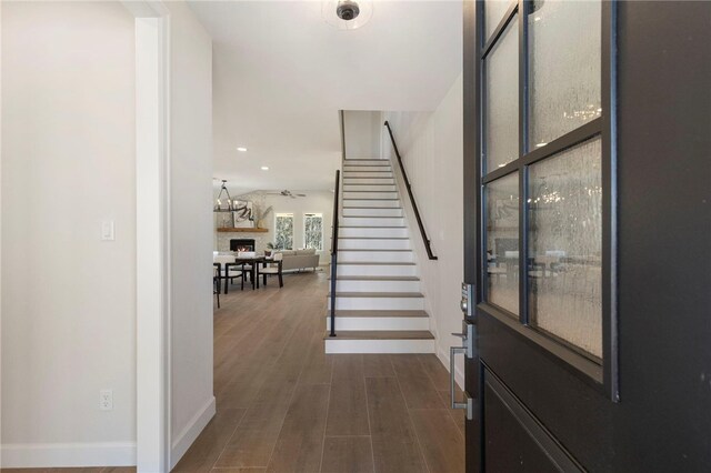 3223 Tamy Ln, Brenham, TX 77833 - foyer featuring stairs, dark wood-style flooring, baseboards, recessed lighting, and a lit fireplace