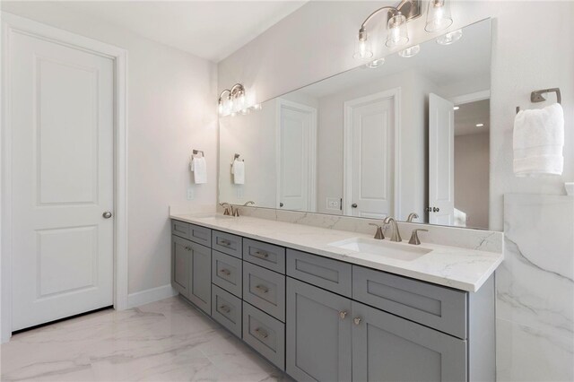 3223 Tamy Ln, Brenham, TX 77833 - bathroom with double vanity, marble look tiles, and baseboards