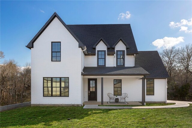 3223 Tamy Ln, Brenham, TX 77833 - modern farmhouse with a porch, a front yard, and roof with shingles