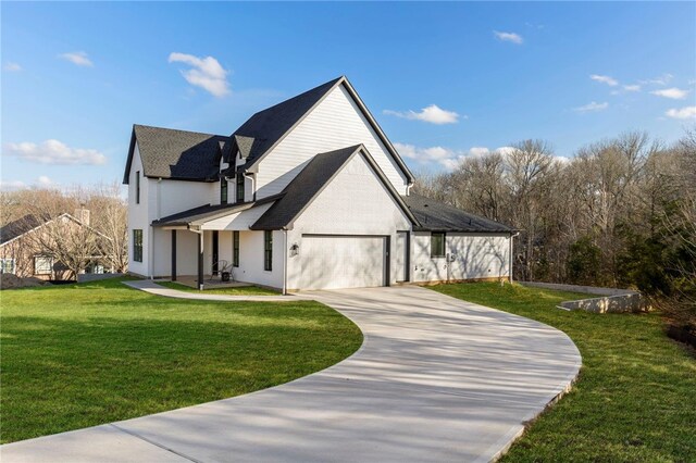 3223 Tamy Ln, Brenham, TX 77833 - view of front of property with driveway, a front yard, a garage, and a shingled roof