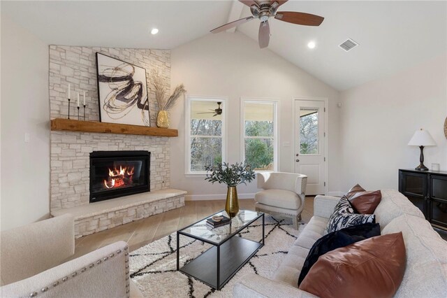 3223 Tamy Ln, Brenham, TX 77833 - living room with wood finished floors, a ceiling fan, a stone fireplace, beam ceiling, and recessed lighting