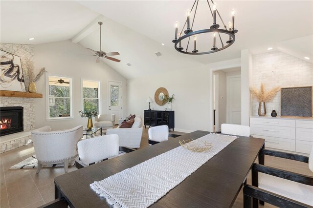 3223 Tamy Ln, Brenham, TX 77833 - dining area featuring beam ceiling, a stone fireplace, a ceiling fan, a chandelier, and high vaulted ceiling