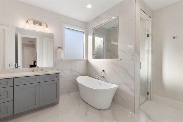 3223 Tamy Ln, Brenham, TX 77833 - bathroom featuring a marble finish shower, marble tiled flooring, a soaking tub, and vanity