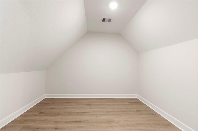 3223 Tamy Ln, Brenham, TX 77833 - additional living space with lofted ceiling, light wood-style flooring, and baseboards